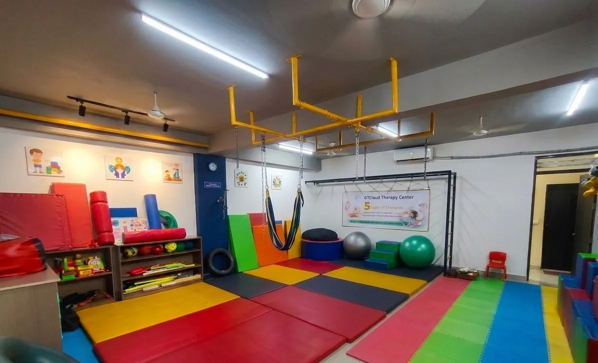 Assessment and learning room with a child-height activity table and learning charts.