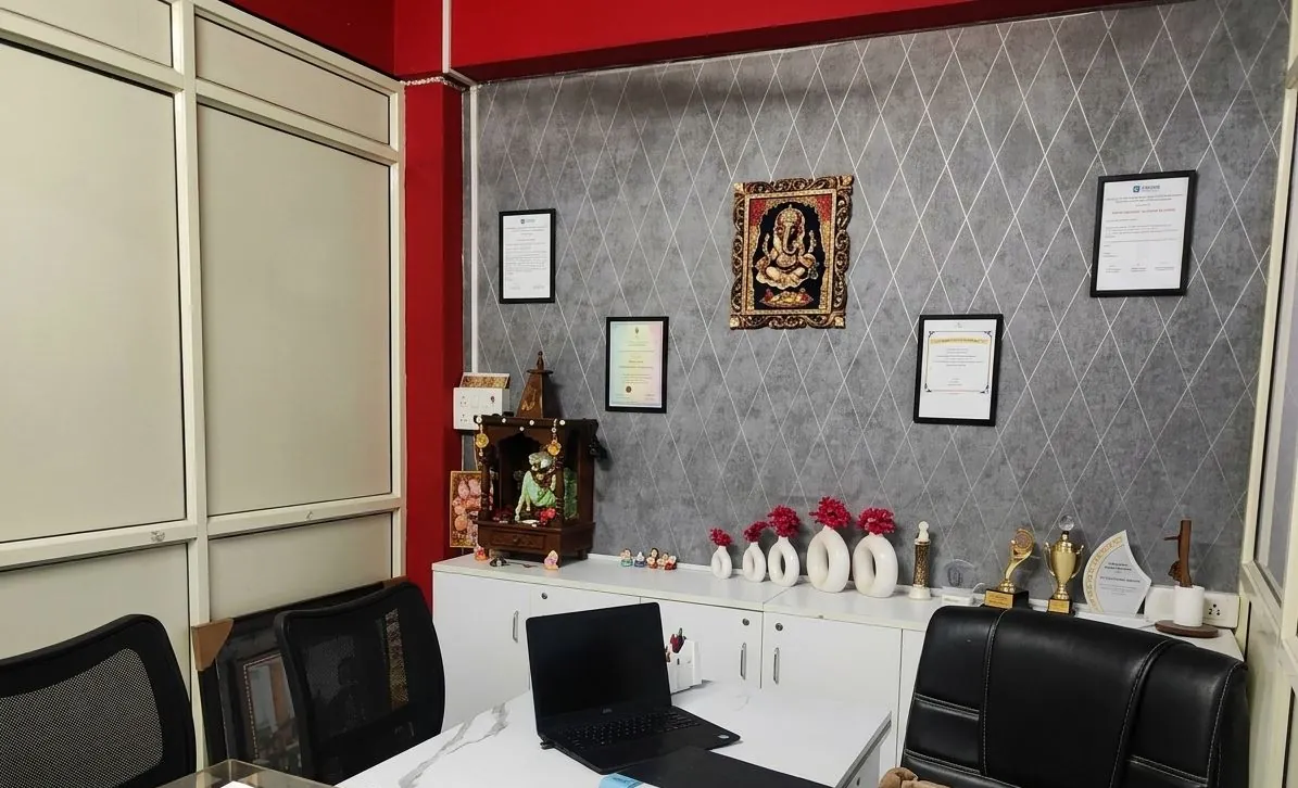 Parent consultation room with the clinician's desk, certificates and awards.