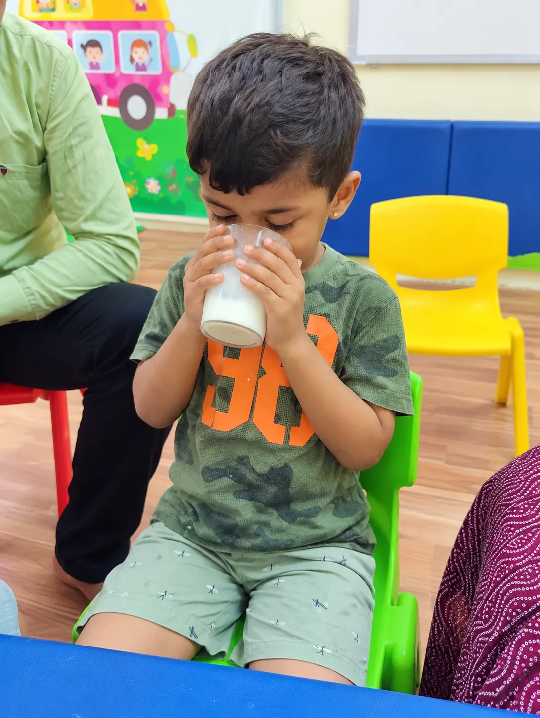 A child practising drinking independently — feeding and oral skills are part of speech and language therapy.